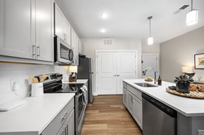 Columbus townhouse for rent - A modern kitchen with white cabinets and stainless steel appliances.