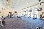 Columbus apartment for rent - a gym with weights and cardio equipment in a building with windows