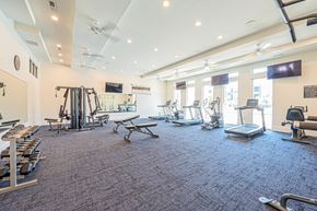 Columbus apartment for rent - a gym with weights and cardio equipment in a building with windows