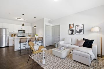 Grove City apartment for rent - A modern living room with a white couch and a patterned rug.