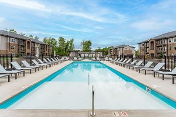Columbus apartment for rent - A large swimming pool surrounded by sun loungers and apartment buildings.