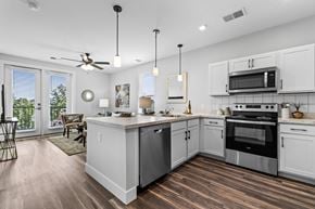 Columbus apartment for rent - A modern kitchen with white cabinets and stainless steel appliances.