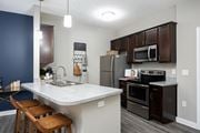 Hilliard apartment for rent - a kitchen with stainless steel appliances and a marble counter top