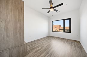 Dayton apartment for rent - A room with a ceiling fan and a window showing a building outside.