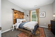 Hilliard apartment for rent - a bedroom with a bed and a window with a barn door