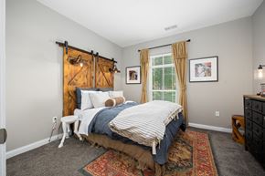 Hilliard apartment for rent - a bedroom with a bed and a window with a barn door