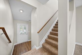 Westerville townhouse for rent - A staircase with a carpeted runner and wooden handrail.