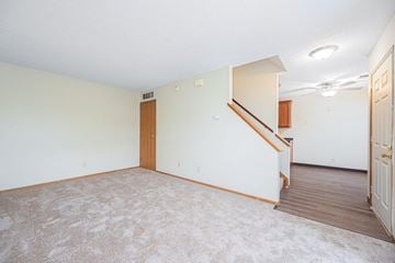 Dublin apartment for rent - a living room with carpet and a door to a staircase