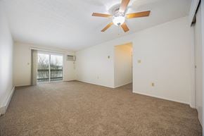 Newark apartment for rent - A room with a ceiling fan and carpeted floor.