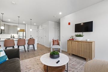 Columbus apartment for rent - A living room with a white table and brown chairs.
