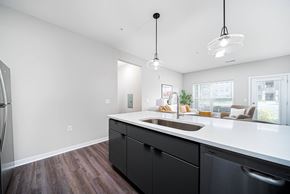 Westerville apartment for rent - A kitchen with black cabinets and a white countertop.