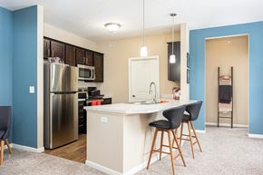 Dublin townhouse for rent - a kitchen with a island and a stainless steel refrigerator