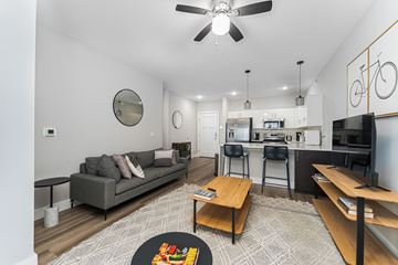 Columbus apartment for rent - A living room with a grey couch and a wooden coffee table.