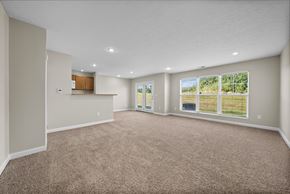 Westerville townhouse for rent - A spacious room with carpeted floor and large windows.
