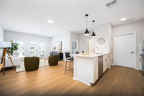 Sunbury apartment for rent - A modern kitchen with white cabinets and a wooden floor.