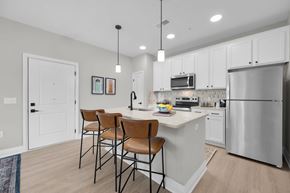 Marysville apartment for rent - A kitchen with white cabinets and a stainless steel refrigerator.