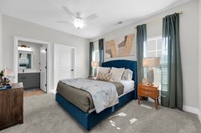 Marysville apartment for rent - A bedroom with a large bed and a ceiling fan.