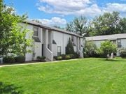 Worthington townhouse for rent - a white apartment building with a green lawn and trees