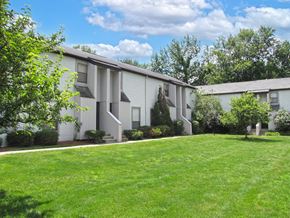Worthington townhouse for rent - a white apartment building with a green lawn and trees