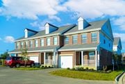 Lewis Center townhouse for rent - A red car is parked in front of a two-story house.