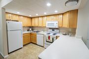 Galloway apartment for rent - a kitchen with white appliances and wooden cabinets
