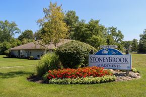 Galloway apartment for rent - the sign for stoneybrook in front of a garden with colorful flowers