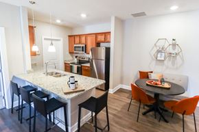 Grove City townhouse for rent - a kitchen and dining area with a granite counter top and stainless steel appliances