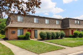Reynoldsburg townhouse for rent - a brick apartment building with a sidewalk in front of it