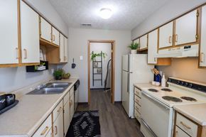 Galloway townhouse for rent - the preserve at ballantyne commons apartment kitchen with white appliances and white cabinets