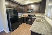 Canal Winchester apartment for rent - a kitchen with black appliances and a granite counter top