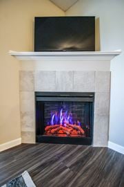 Canal Winchester apartment for rent - a fireplace with a tv above it