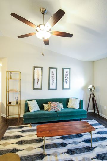 Canal Winchester apartment for rent - a living room with a green couch and a ceiling fan