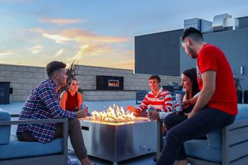 Cozy outdoor fireplace surrounded by plush seating