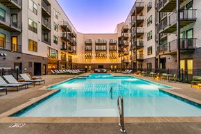 Columbus apartment for rent - A large outdoor swimming pool in front of apartment buildings.
