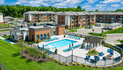 Sunbury apartment for rent - A large building with a pool in front of it.