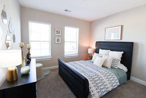 Grove City townhouse for rent - a bedroom with a bed and two windows