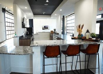 Modern clubhouse featuring garage doors for a dual indoor / outdoor atmosphere