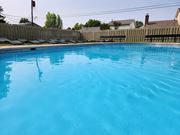 Grove City townhouse for rent - a large swimming pool with a fence around it