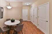 Columbus apartment for rent - a dining room with a table and chairs and a hallway with white doors