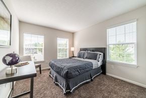 Lewis Center townhouse for rent - a bedroom with a bed and two windows