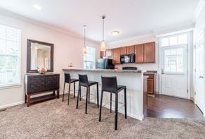 Lewis Center townhouse for rent - a kitchen with a bar with three stools