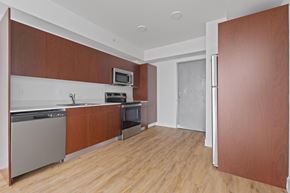 Opa Locka apartment for rent - A kitchen with wooden cabinets and a white oven.