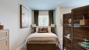 Atlanta apartment for rent - A bedroom with a large bed and a wooden wardrobe.