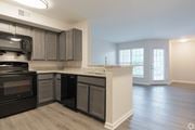 Atlanta apartment for rent - A kitchen with a black oven and microwave.