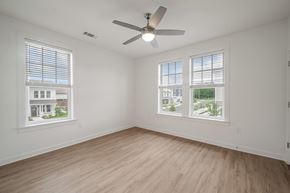 Baton Rouge apartment for rent - A room with a ceiling fan and two windows.