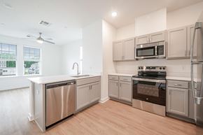 Baton Rouge apartment for rent - A kitchen with stainless steel appliances and wooden floors.