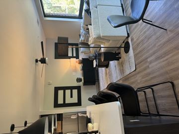 Atlanta apartment for rent - A modern living room with a white couch and a black chair.