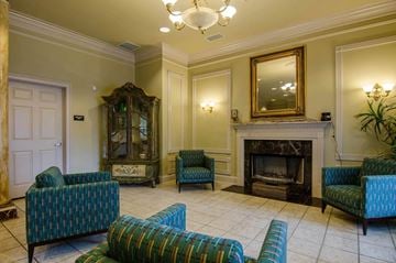 Atlanta apartment for rent - a living room with blue chairs and a fireplace