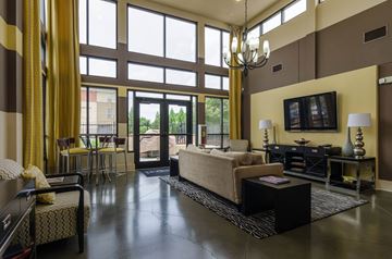 Atlanta apartment for rent - a large living room with large windows and a couch
