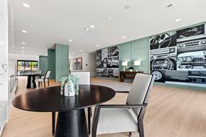 Atlanta apartment for rent - a dining room with a table and chairs in front of a wall mural of cars
